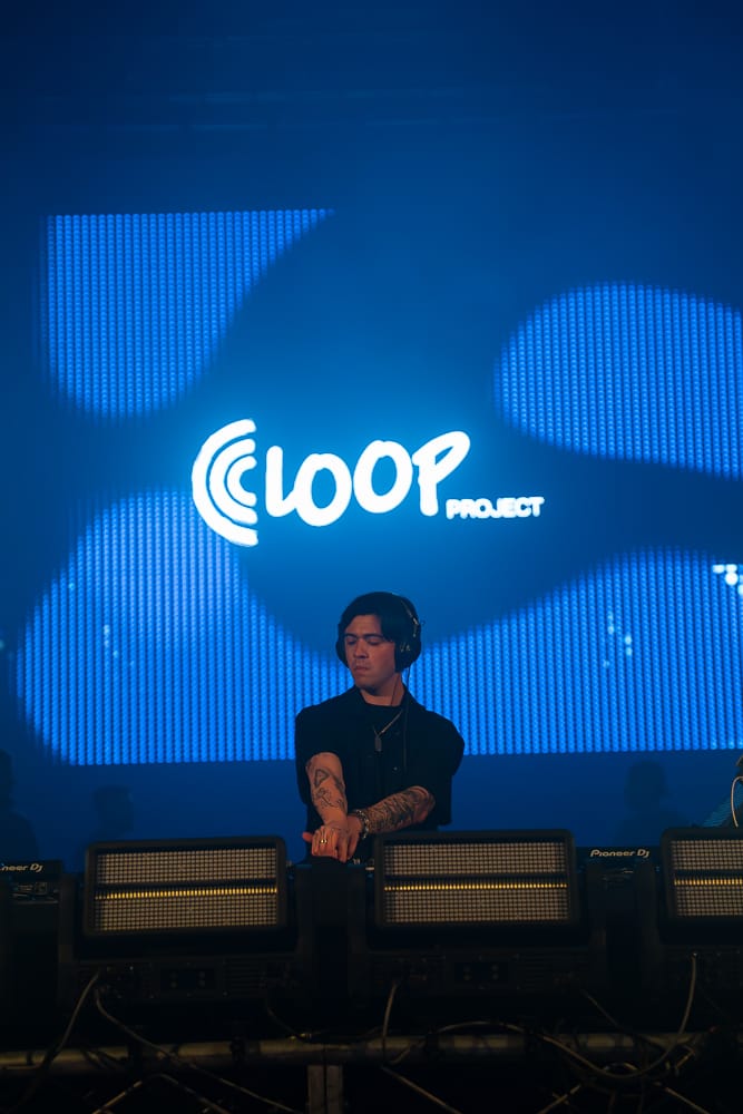DESIGG at LOOP PROJECT, seated against the LED wall carrying the venue logo